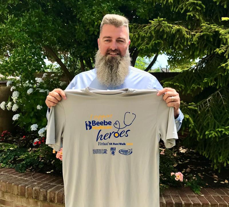 Christian Hudson shows his race shirt from last year’s inaugural Beebe Heroes 5K Walk/Run. SUBMITTED PHOTO
